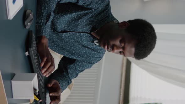 Vertical Video Black Man Computer User Working From Home in Cozy Flat