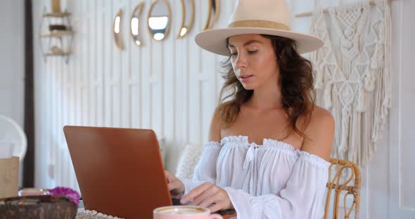 Woman on Freelance Works at White Cafe She Types on Computer and Drinks Coffee