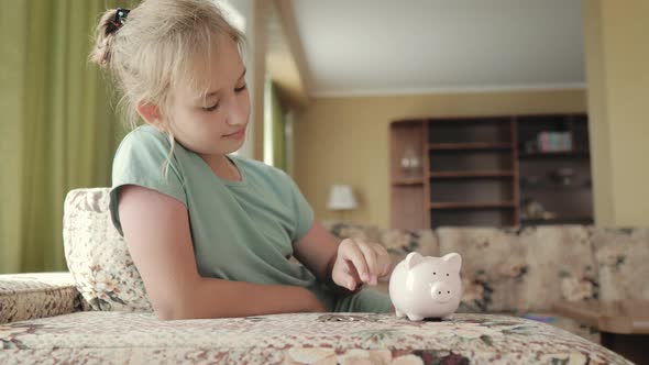 Girl Putting Coin in Piggy Bank Saving Money Concept