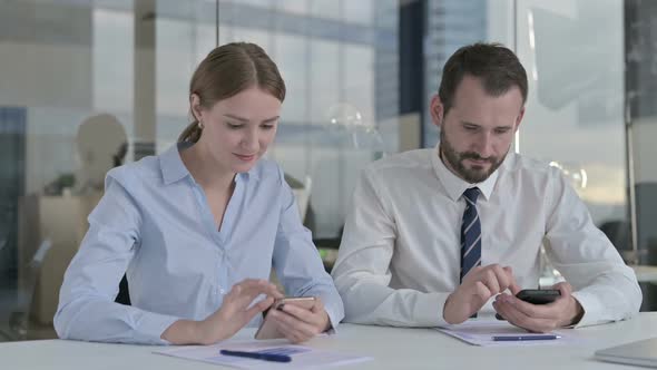 Executive Business People Using Cellphone on Board Room Desk