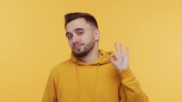 Expressive young man screaming and shouting over vibrant background.