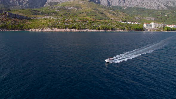 Drone  Footage of the Motor Boat Sailing Near the Sea Shore in the Sunny Day