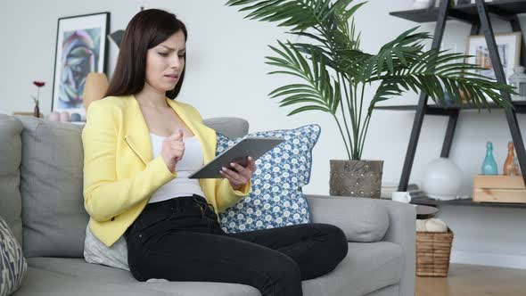 Frustrated Woman Reacting to Failure, while Using tablet