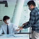 Employees submit documents at their office while wearing masks during the outbreak of the virus. - VideoHive Item for Sale