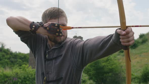 a Young Guy Shoots a Bow at a Target in Nature and Hits the Target the Arrow Pierces the Target for