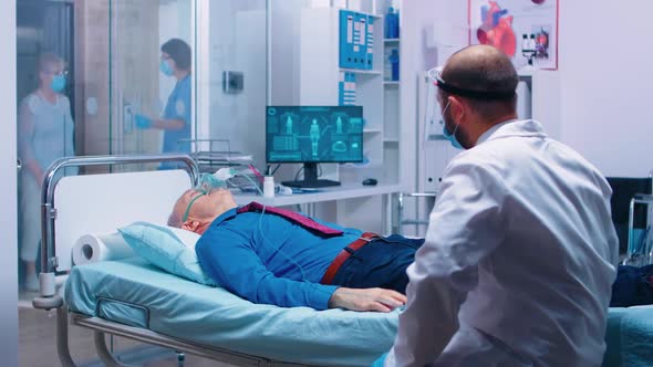 Doctor Talking with Patient with Oxygen Mask