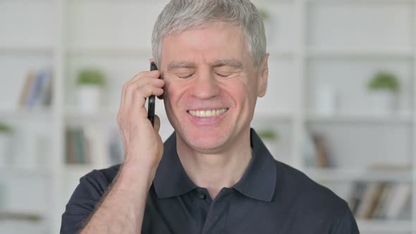 Cheerful Middle Aged Businessman Talking on Smartphone