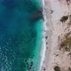 pristine turquoise beach with white sand reflects sunlight on water surface. Aerial zoom out - VideoHive Item for Sale