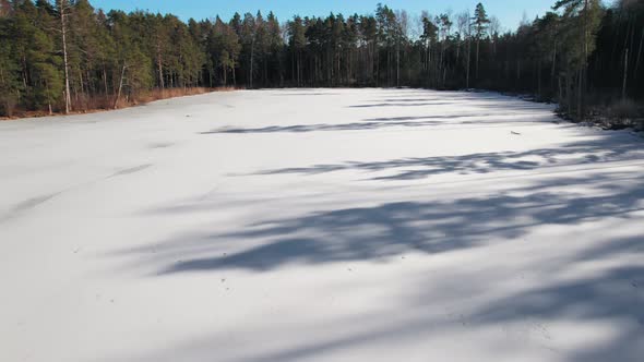 View from the top of the Latvian lake in the Jurmala region, the lake is icy and frozen covered