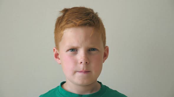 Portrait of Serious Red Hair Boy with Freckles