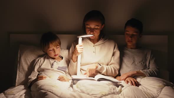 Mom Reading Book to Children