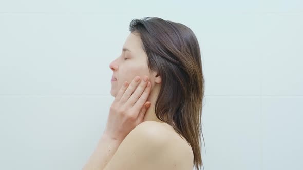 Woman Standing at Shower and Washing Head