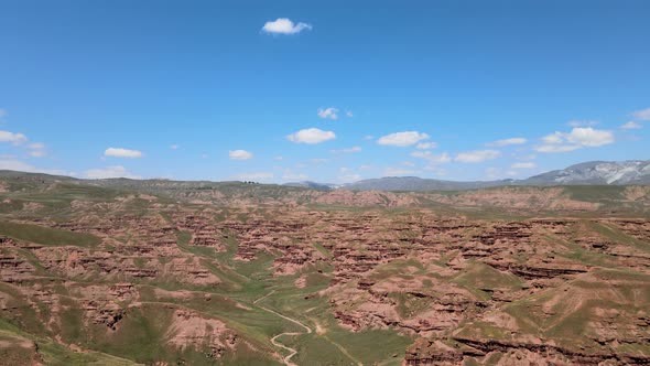green valley and red mountains landscape