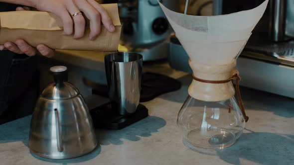 Barista preparing Filter coffee with fresh coffee beans. Trendy drink