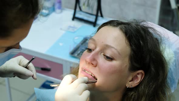 Visit To the Dentist. Orthodontist Corrects Bite with Tracing Paper and Seals