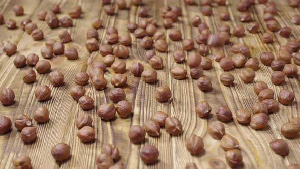 Dried Hazelnuts Lying on a Textured Wooden Table Surface