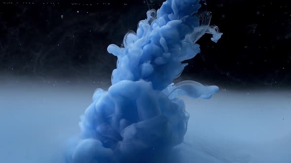 Blue Paint Drops Mixing in Water Slow Motion