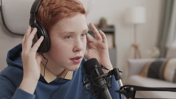 Red-haired Boy Recording Song at Home