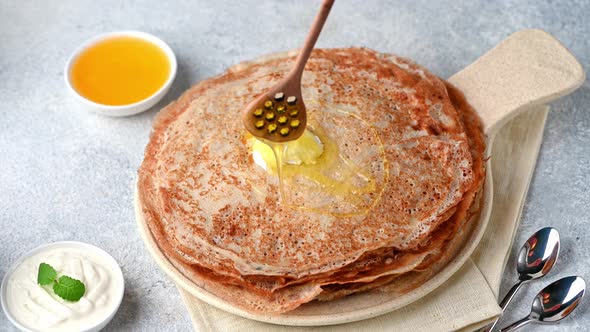 Pancakes with maple syrup. Pancakes with honey. Crepes. Russian blini. Maslenitsa, shrove tuesday