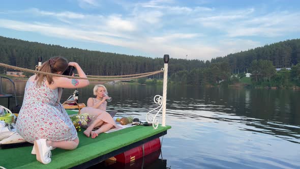 Photography Process a Photographer Shoots a Female Model on a Raft on a Lake