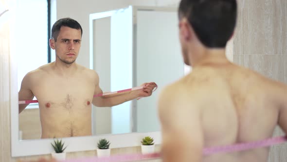 Man Measures a Chest Girth with a Tape Measure