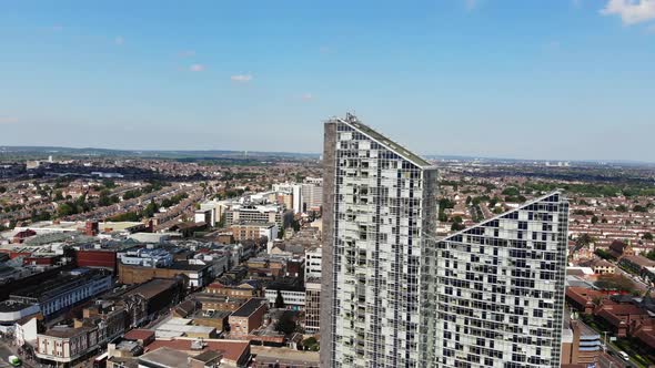 Aerial view raising up pointing down on the two buildings in Ilford, London on a sunny day