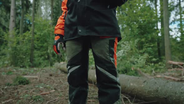 Female Logger Stands in the Forest Young Specialist Woman in Protective Gear Holds an Axe in Her