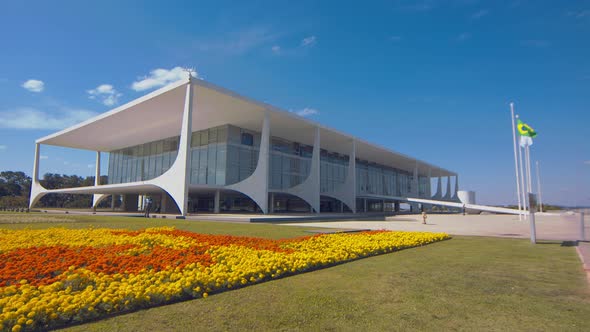 static shot of the palacio do planalto on the three Powers Plaza with the beautiful flower fields on