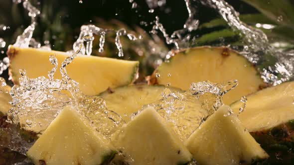 Slow Motion Shot of Pineapple and Water Splashing Through Pineapple Slices