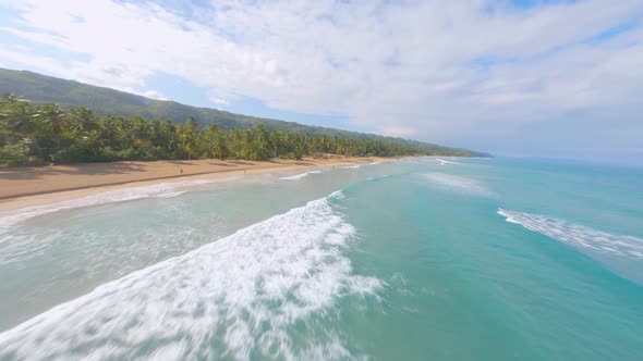 Fpv dynamic flight over beautiful ocean water,sandy beach along coastline with palm trees - Playa Co