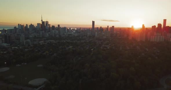 4k Aerial Shot of Toronto at Sunset While Camera Rises and Shows Highway Traffic