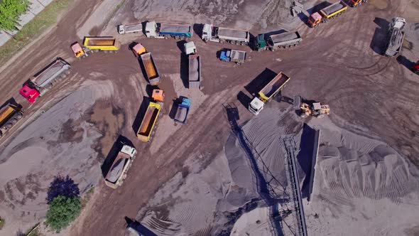 The Excavator Loads the Crushed Stone in a Truck