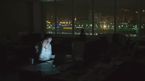 Busy Woman Working in Dark Office