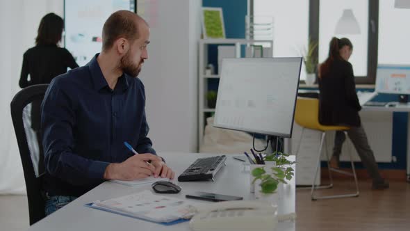 Corporate Employee Taking Notes for Project Planning