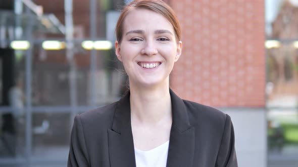 Outdoor Portrait of Smiling Young Businesswoman