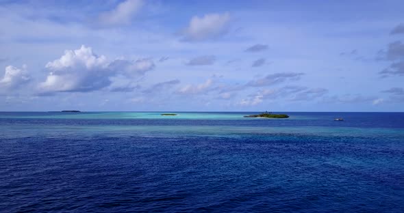 Daytime overhead abstract shot of a summer white paradise sand beach and aqua blue ocean background 