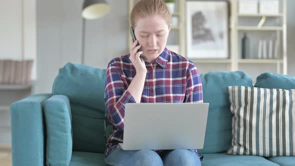 Woman Talking on Phone And Working on Laptop