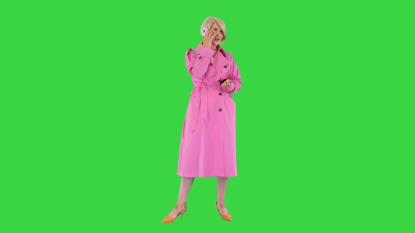 Grandmother Calling Loving Fashionable Modern Grandmother Wearing Pink Trench Coat Making a Call on