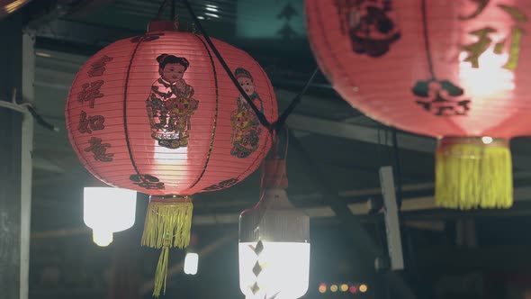 Paper Lanterns with Pictures Hang Under Asian Cafe Ceiling