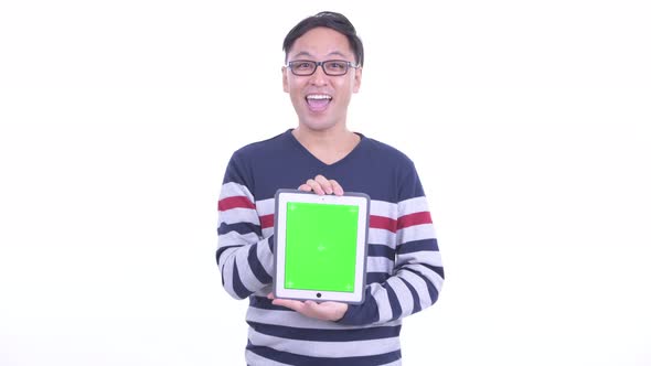 Happy Japanese Hipster Man Talking While Showing Digital Tablet