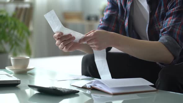 Man Revising Check for Utilities, Calculating Income and Expenses, Family Budget