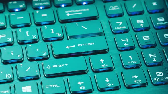 Time lapse laptop keyboard glows different colors. Computer technology