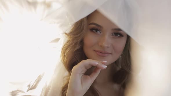 Lovely Portrait of Bride in Veil. Face Close-up. Pretty Gorgeous Woman. Wedding