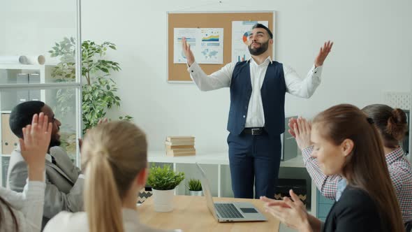 Slow Motion of Cheerful Man Making Report Then Doing Highfive and Dancing While Coworkers Applauding
