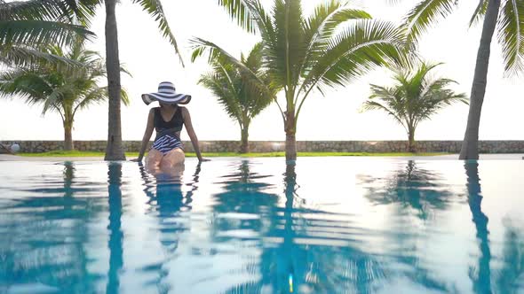 Young asian woman enjoy around outdoor swimming pool for leisure