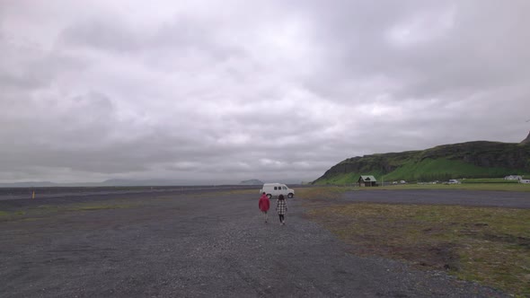 Couple Walking Towards Van In Thingvellir National Park