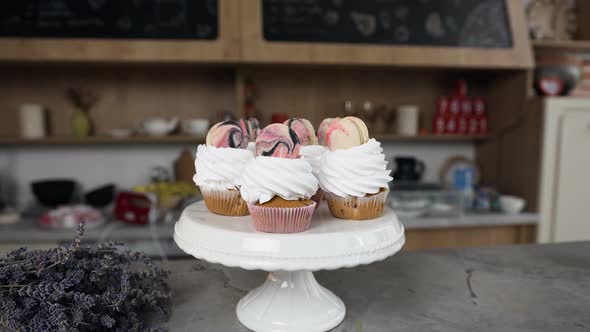 Woman Hands Connecting Two Halves of Macaroons Using Cream