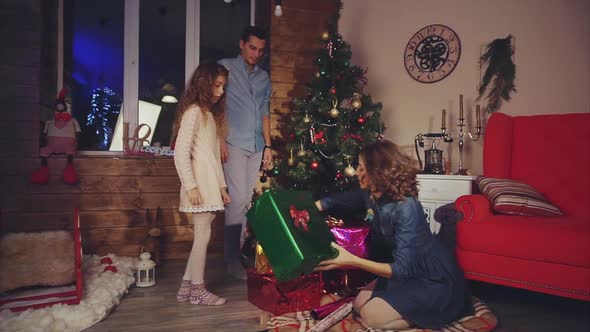 Family Prepares Gifts and Decorate the Christmas Tree