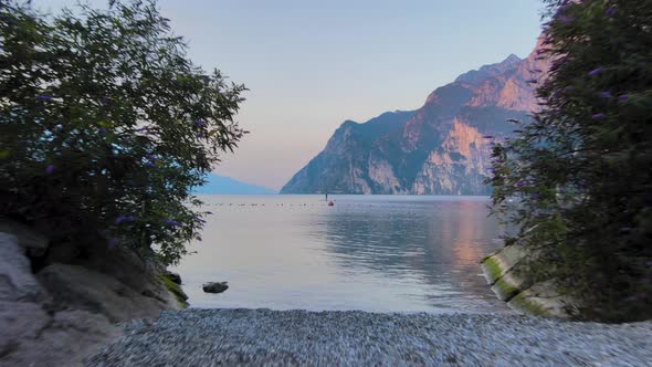 Aerial shot on Garda lake at sunrise. Countryside concept in Riva Del Garda (Trentino). Reveal shot