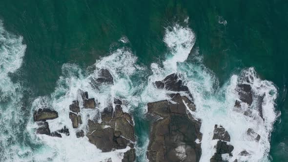 Waves Crash Against Rocks in the Ocean